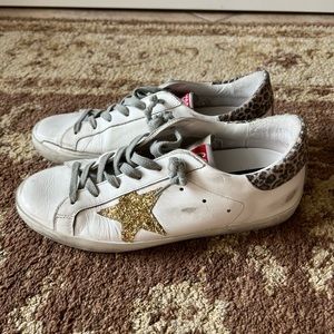 Golden Goose Superstar Sneakers. Gold glitter star with animal print.